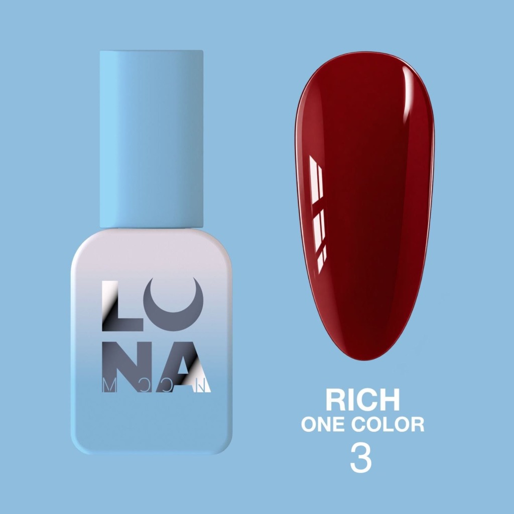 Esmalte rojo oscuro junto a frasco azul